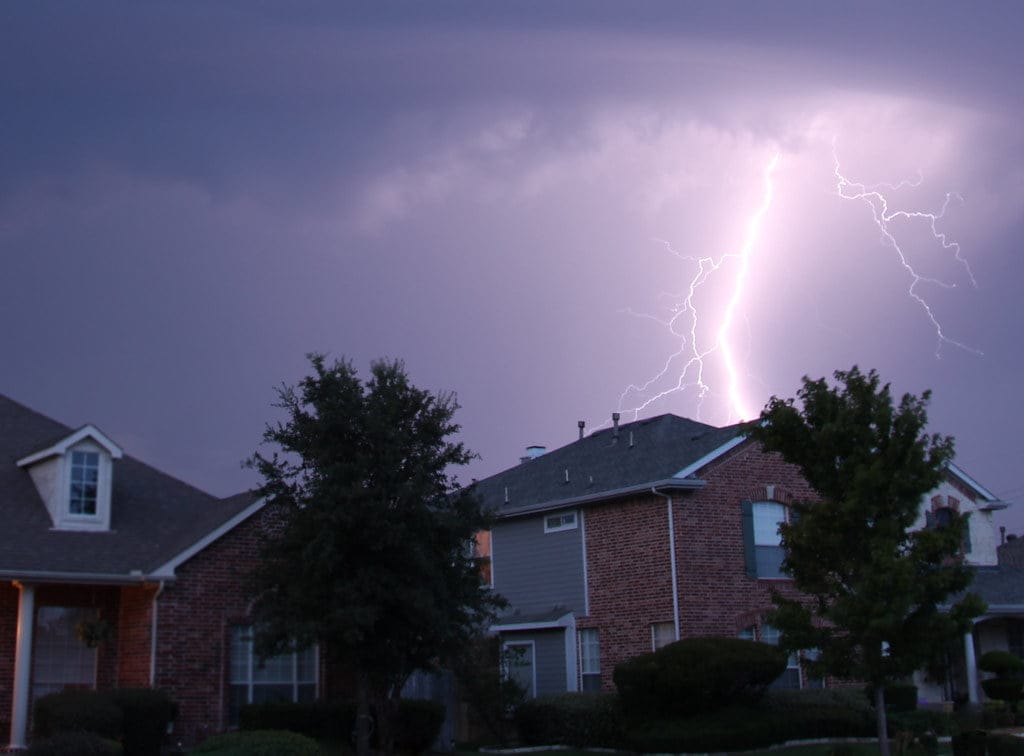 House with lightning strike in the background